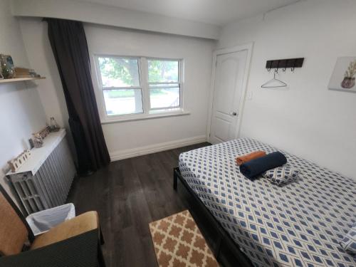 a bedroom with a bed and a window at Affordable Quiet Private Room - 10-min Walk to Subway in Toronto
