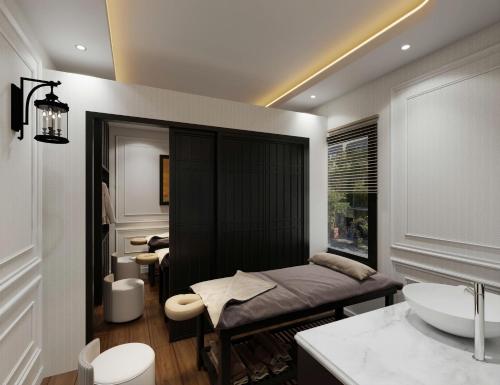 a bedroom with a bed and a sink in a room at Ritana Boutique Hotel & Spa in Hanoi
