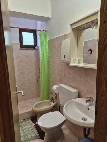 a bathroom with a toilet and a sink at Norma 2 in Novigrad Istria