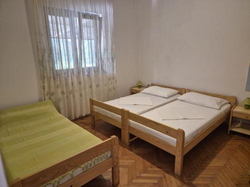 two twin beds in a room with a window at Norma 2 in Novigrad Istria