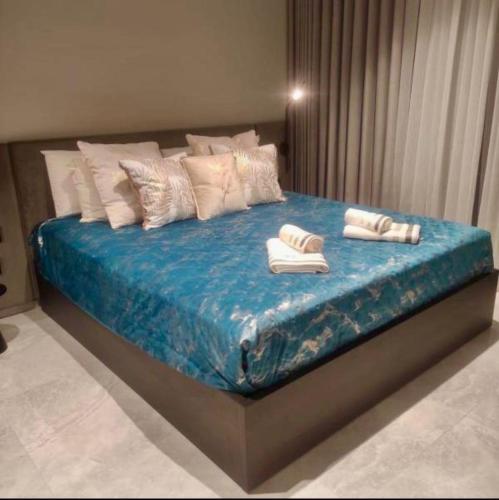 a bed with towels and pillows on top of it at Sky Apartment , 22th Floor Mercury Tower in St. Julianʼs