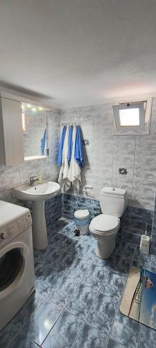 a bathroom with two toilets and a sink and a washing machine at DESPOINA APARTMENT 2 Relax in Nea Michaniona