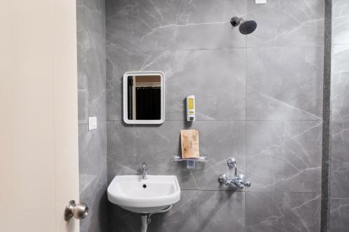 a bathroom with a sink and a mirror at Loop by Zolo HSR Layout, Bangalore in Bangalore