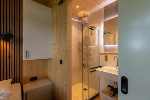 a bathroom with a shower and a toilet and a sink at Zicht op Twente - Spa lodges in Markelo