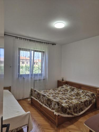 a bedroom with a bed and a window at Norma 3 in Novigrad Istria