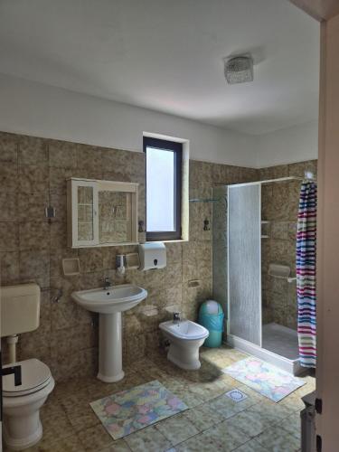 a bathroom with a sink and a toilet and a shower at Norma 3 in Novigrad Istria