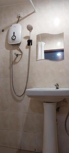 a bathroom with a shower and a sink at LA MOTEL in Sungai Petani