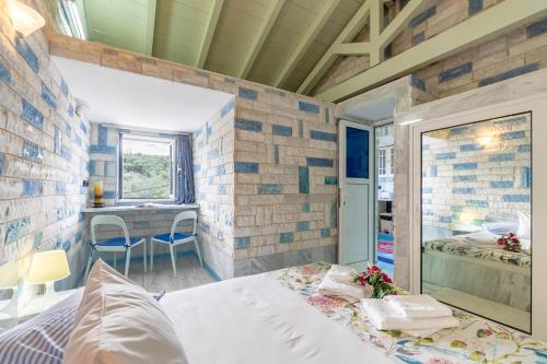 a small room with a bed and a table at Paco's Resort Standard Studio 3 in Oziás