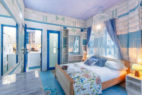 a bedroom with a bed with a canopy at Paco's Resort Superior Villa 7 in Oziás