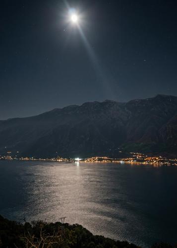 a moonlit view of a body of water at night at Casa Cristina - Vista Lago in Tignale