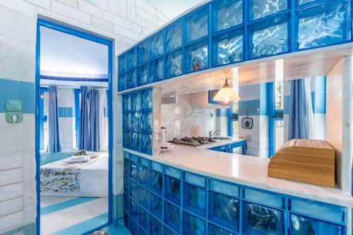a blue and white kitchen with blue tile walls at Paco's Resort Superior Villa 6 in Oziás