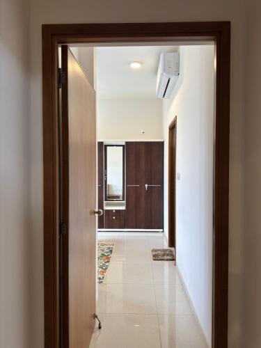 a hallway with a door leading to a bathroom at Sky height 2BHK in GIFT CITY in Gandhinagar