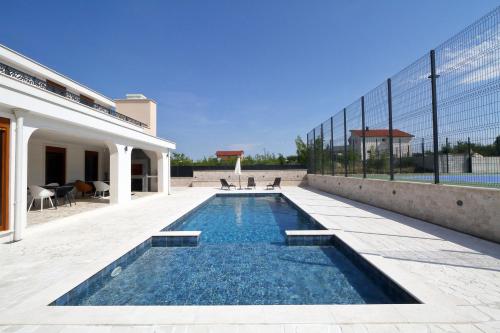 a swimming pool in the backyard of a house at Villa After Set Heaven in Čapljina