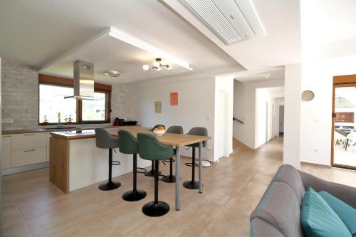 a kitchen and living room with a table and chairs at Villa After Set Heaven in Čapljina