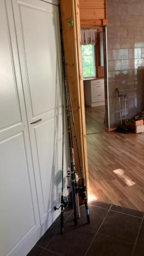 a tripod leaning against a wall next to a door at Villa SULKAVANRANTA in Sulkava