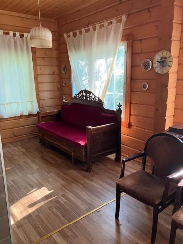 a room with a bench and a window in a log cabin at Villa SULKAVANRANTA in Sulkava