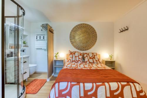 a bedroom with a large bed and a mirror at Chambre jardin in Lunel
