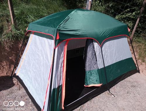 a green and white tent sitting on the ground at Tente tout confort in Sarrancolin