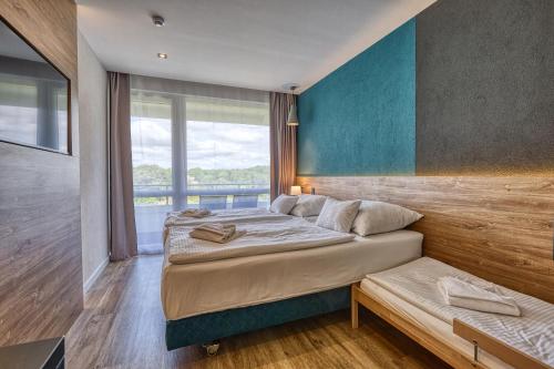 a bedroom with two beds and a window at Hotel Szieszta in Sopron