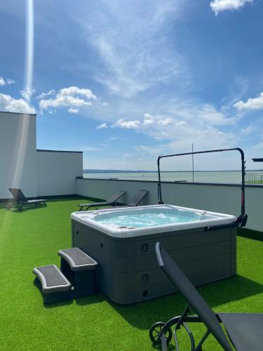 a hot tub on the deck of a cruise ship at Royal Lakeside Apartment in Keszthely