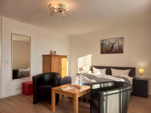 a bedroom with a bed and a table and chairs at Hotel Rosenhof - Braunlage in Braunlage