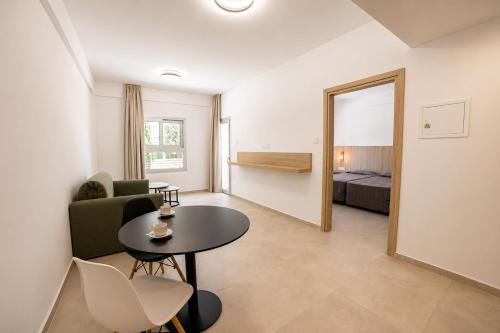 a living room with a table and a couch at Anthea Hotel Apartments in Ayia Napa