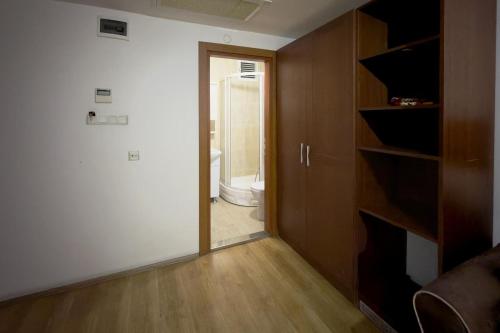 a hallway with a toilet and a door to a bathroom at La Garden Hotel Old City in Istanbul