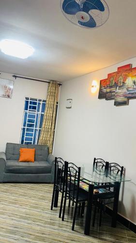 a living room with a glass table and chairs at Varine House in Dodoma