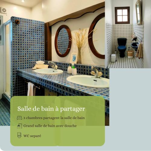 a bathroom with two sinks and two mirrors at Villa Les Chariotins in Draguignan
