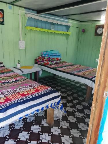 a room with a bunch of beds in it at Karki Farm Stay in Bijanbāri Bāzār