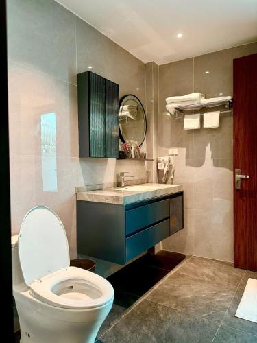 a bathroom with a toilet and a sink and a mirror at NBZ Homestay in Hanoi