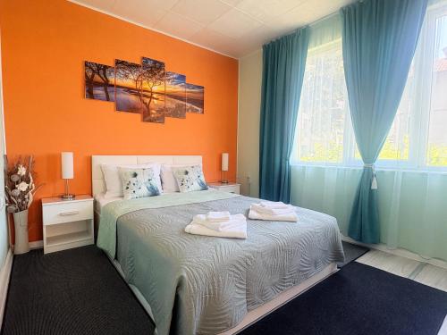 a bedroom with a bed with two towels on it at Velonia Guest House in Sozopol