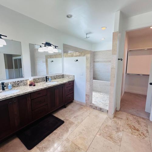 a bathroom with two sinks and a shower at Hale Halai in Hauula