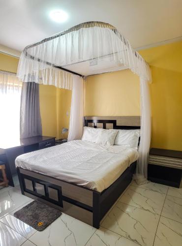 a bed with a canopy in a bedroom at Area 46 BnB in Lilongwe