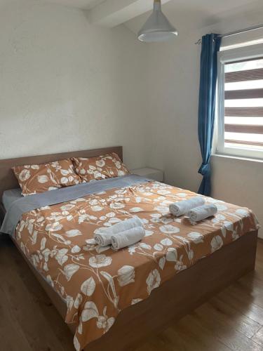 a bedroom with a bed with two towels on it at Villa Apartments STEFAN - Ramne Ohrid in Ohrid