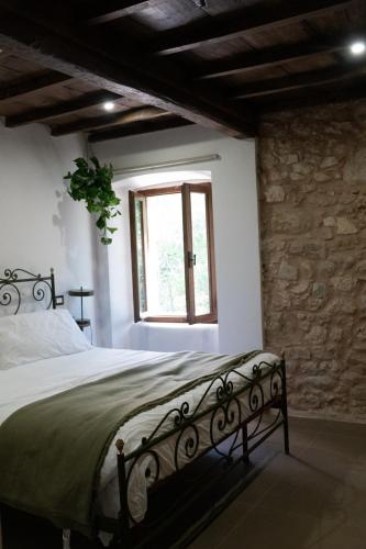 a bedroom with a bed and a window at Casale dei cappuccini in Scurcola Marsicana