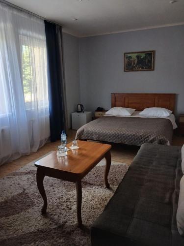 a hotel room with two beds and a coffee table at Casablanca Hotel in Kalush