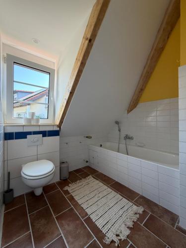 a bathroom with a toilet and a bath tub at Villa Art Residence Überlingen in Überlingen