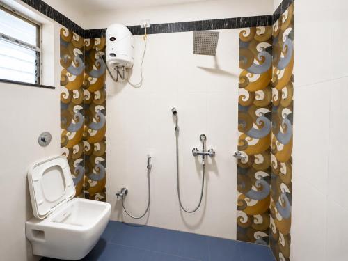 a bathroom with a toilet and a sink and a shower at Hotel Big Boss New Digha in Digha