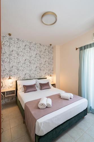 a bedroom with a large bed with towels on it at Fontana La Vista in Sitia