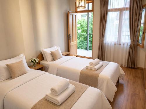 a hotel room with two beds with towels on them at Andranik B&B in Goris