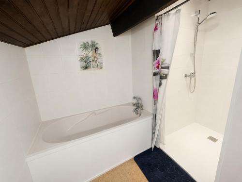 a white bathroom with a tub and a shower at L'Authentique - 5 Voyageurs - Château à 150m in Villeneuve