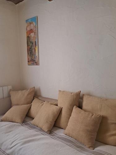 a bunch of pillows sitting on top of a bed at Au coeur d'Uzès in Uzès