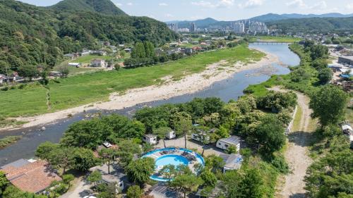 an aerial view of a river and a city at Gapeyong Donghwa Caravan in Gapyeong