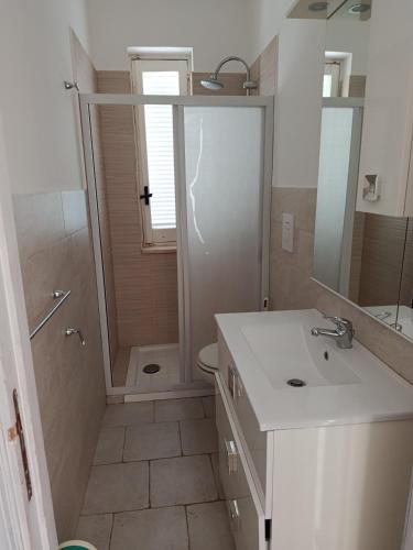 a bathroom with a toilet and a sink and a shower at SALENTO VACANZE 2 nuova gestione in Villanova di Ostuni
