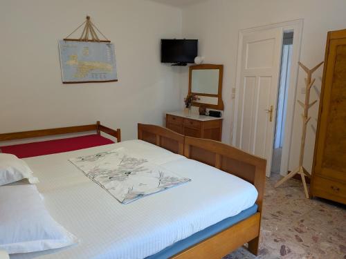 a bedroom with a bed and a mirror and a television at Seaside Villa Katrine in Banjol