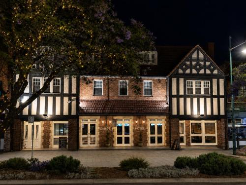 an old building at night with lights at Camden Hotel Suites in Camden