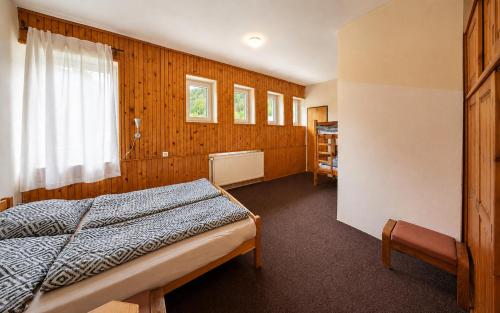 a bedroom with a bed and a window at Bouda Morava - snídaně v ceně - klidné Krkonoše in Dolni Dvur