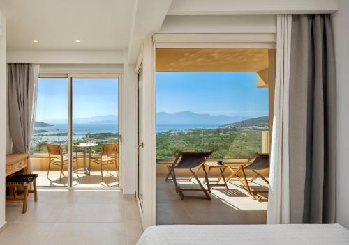 a bedroom with a view of a room with a bed at Elounda Heights (Adults Only) in Elounda