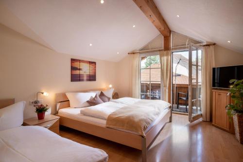 a bedroom with two beds and a large window at Appartement Irmgard in Brixen im Thale